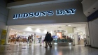Pedestrians walk past a Hudson's Bay Co. store in North Vancouver. 