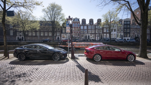 A Tesla Inc. Model 3, right, and a Model S electric automobile recharge at a charging station beside a canal in Amsterdam, Netherlands, on Monday, April 1, 2019. With 5,315 new cars registered, Tesla’s Model 3 accounted for 29 percent of the new sales. 
