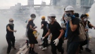 Demonstrators react to a cloud of tear gas near the Legislative Council in Hong Kong, June 12 2019 
