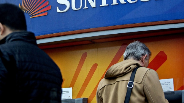 A customer uses an ATM at a SunTrust Banks Inc. branch in Washington, D.C. 