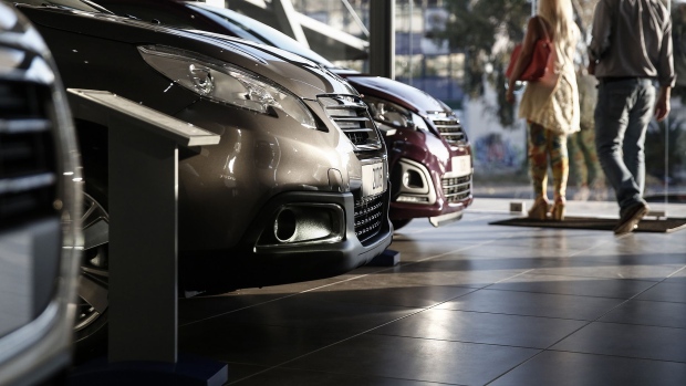 Customers exit after viewing vehicles at a dealership in the Glyfada district of Athens. 