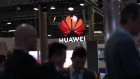 An illuminated logo hangs above the Huawei Technologies Co. pavilion on the opening day of the MWC Barcelona in Barcelona. 