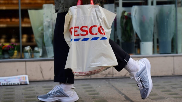 A customer carries a bag of shopping from a Tesco Plc supermarket in London, U.K., on Tuesday, Jan. 8, 2019. Investors looking for relief from the tumult of global markets may want to avert their eyes from a report showing that by one measure, U.K. retail sales had their worst year in more than a decade. 