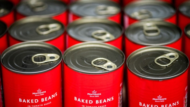 Tins of own brand baked beans sit on a shelf inside a Morrisons supermarket, operated by Wm Morrison Supermarkets Plc, in London, U.K., on Wednesday, Aug. 8, 2018. Morrisons reported a growth in profits in their most recent financial year, boosted by food price inflation. 