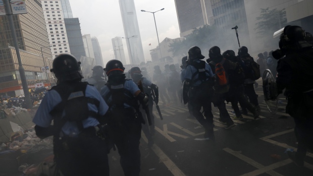 Riot police block Connaught Road Central during a protest against a proposed extradition law in Hong Kong, China, on Wednesday, June 12, 2019. Protesters flooding downtown Hong Kong to stop the government's proposed extradition law effectively presented the city's leaders with an ultimatum: back down, or risk violent clashes that could be worse than the Occupy movement in 2014. Photographer: Justin Chin/Bloomberg