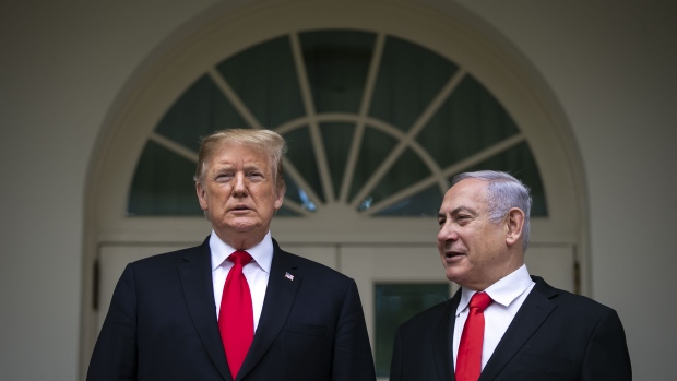 Benjamin Netanyahu, Israel's prime minister, right, speaks with U.S. President Donald Trump while standing for photographs in the Rose Garden of the White House in Washington on March 25, 2019. 
