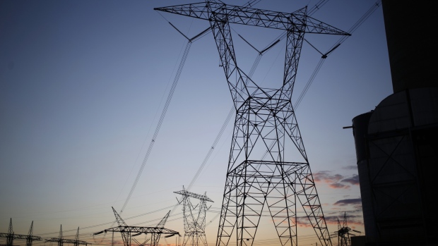 Transmission lines stand at the American Electric Power Co. (AEP) coal-fired John E. Amos Power Plant at dusk in Winfield, West Virginia, U.S., on Wednesday, July 18, 2018. American Electric Power Co., Duke Energy Corp., and others say they can't recoup money they spent to meet requirements to cut mercury and other air toxics from their facilities and therefore want the Environmental Protection Agency (EPA) to retain the Mercury and Air Toxics Standards (MATS) rule as is. 