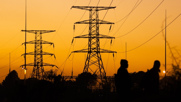 Electrical transmission pylons are silhouetted as the sun rises at dawn in the Saulsville township, Pretoria, South Africa, on Friday, May 31, 2019. While South African President Cyril Ramaphosa says power utility Eskom Holdings SOC Ltd. is considered too big to fail, it could be too big to support because of the costs associated with stabilizing its finances, Engineering News reported, citing S&P Global Ratings Director Ravi Bhatia. 