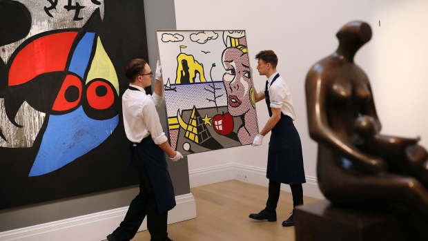 LONDON, ENGLAND - APRIL 09: Sotheby's employees pose with a painting entitled 'Still Life with Head', 1976, by Roy Lichtenstein during a UK preview of the 'Impressionist and Modern Art' sale on April 9, 2018 in London, England. The work is expected to fetch between $7-10M USD, when it goes for auction at Sotheby's auction house in New York on May 14, 2018. (Photo by Dan Kitwood/Getty Images)