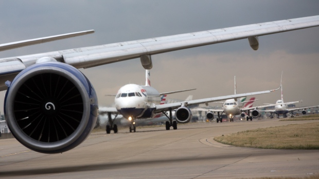 A row of passenger aircraft line up ahead of take off from London Heathrow airport in London, U.K., on Friday, Oct. 7, 2016. Europe's busiest hub is stepping up its pitch for a new runway with a much-delayed U.K. government decision on where to locate additional flight capacity for southern England likely to announced in the coming weeks. 
