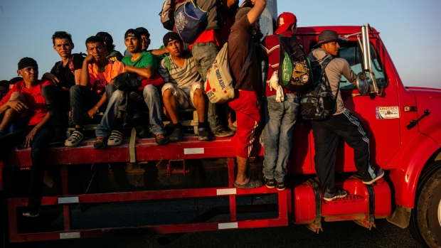 Central American refugees walk along a road in Mexico. Photographer: Jordi Ruiz Cirera/Bloomberg