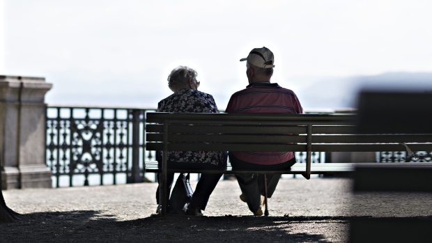 An elderly couple sit on a bench by Lake Zurich in Zurich, Switzerland, on Wednesday, Aug. 23, 2017. 
