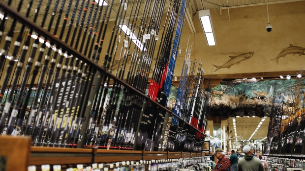 Shoppers browse fishing rods and equipment at a Bass Pro Outdoor World LLC store on Black Friday in Tampa, Florida, U.S., on Friday, Nov. 23, 2018. Deloitte expects sales from November to January to rise as much as 5.6 percent, to more than $1.1 trillion, marking the best holiday period in recent memory. 