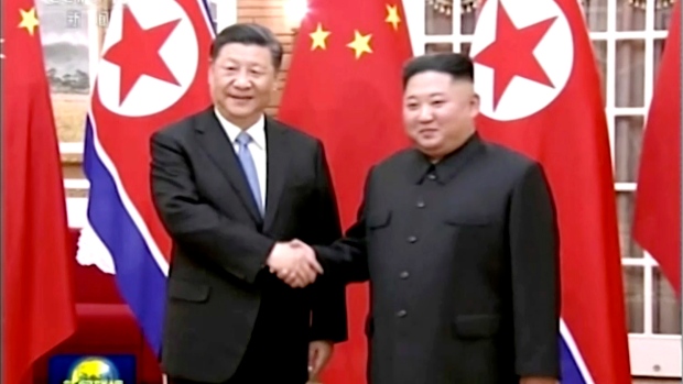 Chinese President Xi Jinping, left, and North Korean leader Kim Jong Un, right