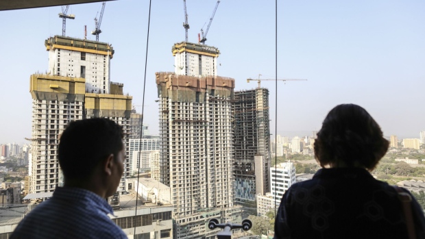People look at out at the construction site of Lodha The Park, a luxury residential project developed by Lodha Developers Ltd., in Mumbai, India, on Monday, April 24, 2017. Lodha, one of India's largest property developers, will resume marketing apartments in the 75-story Trump Tower Mumbai development in the next few months, said Managing Director Abhishek Lodha. 