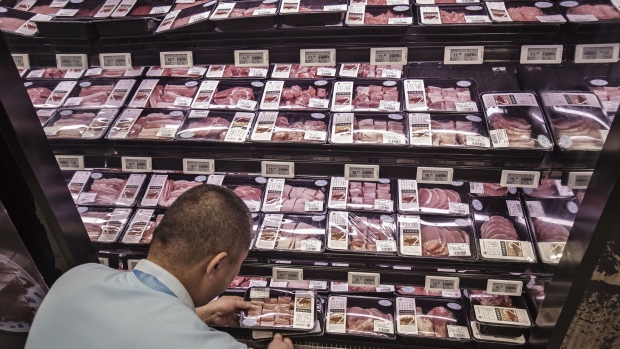 An employee arranges packs of meat on shelves at an Alibaba Group Holding Ltd. Hema Store in Shanghai, China, on Tuesday, Sept. 12, 2017. Hema stores are one-stop shops where users can pay with their mobile app, get recommendations by scanning product bar codes, and have seafood cooked on the spot, and also serving as last-mile delivery fulfillment centers, where goods get to buyers within 30 minutes. 