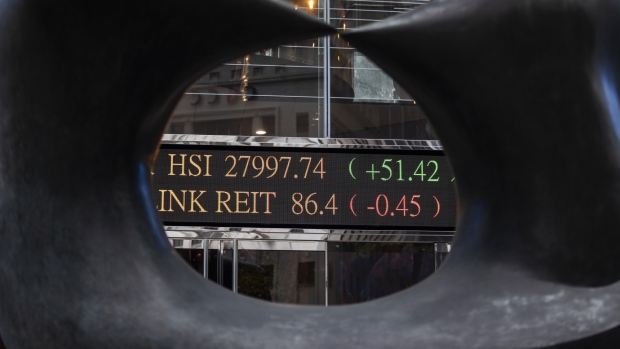 An electronic ticker board displaying stock figures is seen through an art installation outside the Exchange Square complex, which houses the Hong Kong Stock Exchange, in Hong Kong, China, on Monday, Feb. 11, 2019. The bullish mood building in China’s equity market is entering a new phase, with investors flocking to riskier stocks as trading reopened Monday. 