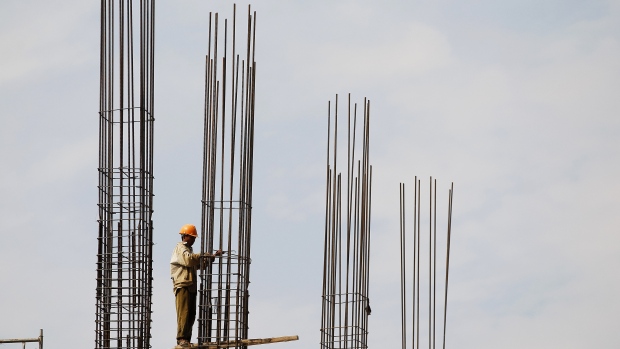 A construction worker binds reinforcing steel at a construction site in Hanoi, Vietnam 
