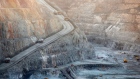 Mining trucks and machinery operate in the Fimiston Open Pit, known as the Super Pit, in Kalgoorlie, Australia. 