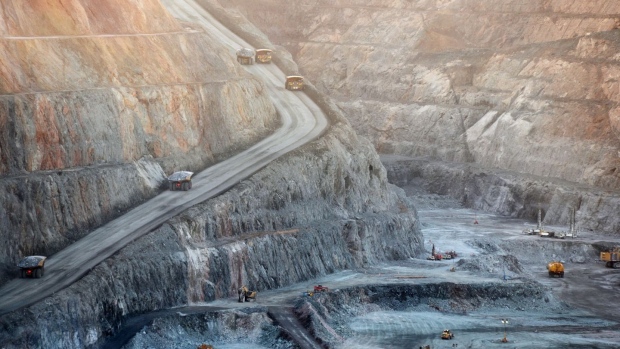 Mining trucks and machinery operate in the Fimiston Open Pit, known as the Super Pit, in Kalgoorlie, Australia. 