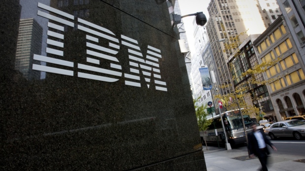 Pedestrians walk past International Business Machines Corp. (IBM) offices in New York, U.S., on Monday, Nov. 14, 2011. 