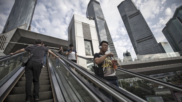 Pedestrians ride an escalator in the Lujiazui Financial District in Shanghai, China, on Monday, Sept. 4, 2017. The Chinese central bank's tight leash on liquidity is straining the bond market, with the benchmark sovereign yield climbing to near the highest level since April 2015. 