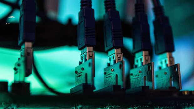 Lights illuminate USB cables inside a 'mining rig' computer, used to mine cryptocurrency, in Budapest, Hungary, on Wednesday, Jan. 31, 2018. Cryptocurrencies are not living up to their comparisons with gold as a store of value, tumbling Monday as an equities sell-off in Asia extended the biggest rout in global stocks in two years. 