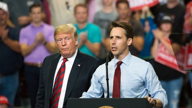 Josh Hawley, right, speaks as U.S. President Donald Trump looks on during a rally in Springfield, Missouri, U.S., on Friday, Sept. 21, 2018. Trump vowed to rid the Justice Department and FBI of "bad" people, echoing previous criticism he's made that the law enforcement agencies he controls are tainted by political bias. Photographer: Bloomberg/Bloomberg