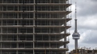 The CN Tower stands behind a condominium building under construction in downtown Toronto, Ontario, Canada, on Thursday, May 10, 2018. The dollar value of building permits for multiple-unit homes exceeded single-unit properties for the first time on a quarterly basis between January and March. 