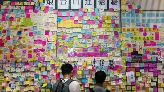 In another corner of Mong Kok, a second wall sprouts. Photographer: Justin Chin/Bloomberg