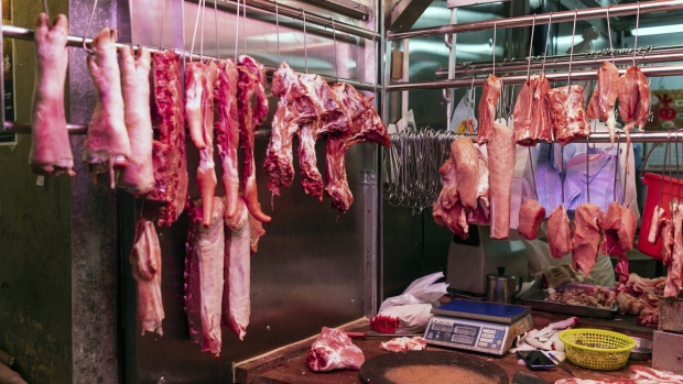 Cuts of pork hang on display for sale at a market stall in Hong Kong, China, on Saturday, May 11, 2019. China has suspended the transport of all live pigs to Hong Kong after the first case of African swine fever was found in the city, according to local media reports on May 12. 