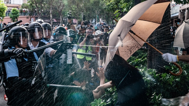 HONG KONG, CHINA - JULy 13: Police officers use pepper spray to disperse protesters after a rally in Sheung Shui district on July 13, 2019 in Hong Kong, China. Protesters in Hong Kong clashed with the police after thousands rallied in Sheung Shui against mainland Chinese parallel traders on Sunday while pro-democracy demonstrators continued weekly rallies on the streets of Hong Kong for the past month, calling for the complete withdrawal of a controversial extradition bill. Hong Kong's Chief Executive Carrie Lam has suspended the bill indefinitely, however protests have continued with demonstrators now calling for her resignation. (Photo by Anthony Kwan/Getty Images) 