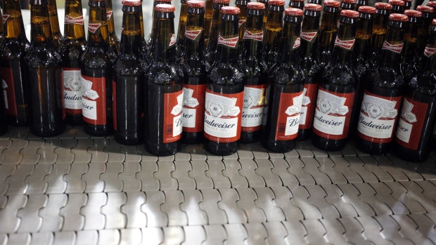 Bottles of beer move along a conveyor belt at the Anheuser-Busch InBev NV Budweiser bottling facility in St. Louis. 
