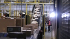 Sealed boxes move along a conveyor into a truck dock ahead of shipping from an Amazon.com Inc. fulfilment center during the online retailer's Prime Day sales promotion day in Koblenz, Germany. 