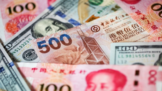 A Hong Kong five-hundred dollar banknote, Chinese one-hundred yuan banknotes and U.S. one-hundred dollar banknotes are arranged for a photograph in Hong Kong, China, on Monday, April 15, 2019. China's holdings of Treasury securities rose for a third month as the Asian nation took on more U.S. government debt amid the trade war between the world’s two biggest economies. 