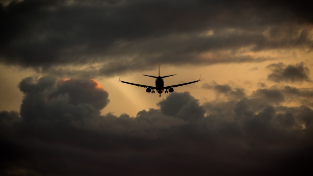 A Boeing Co. 737-800 aircraft flies towards Vancouver International Airport at sunset after passing near the River Rock Casino Resort in Richmond, British Columbia, Canada, on Friday, April 26, 2019. Vancouver-area casinos for years had been accepting millions of dollars in questionable cash from gamblers showing up with suitcases and hockey bags bulging with bills, according to British Columbia Attorney General David Eby. 