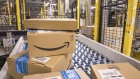 Packed boxes pass along a conveyor belt at the Amazon.com Inc. fulfilment centre in Tilbury, U.K. on Friday, July 12, 2019. By offering 12 extra hours of deals during this year's Prime Day, Amazon will pull in nearly 50% more in sales, according to an estimate from Coresight Research. 