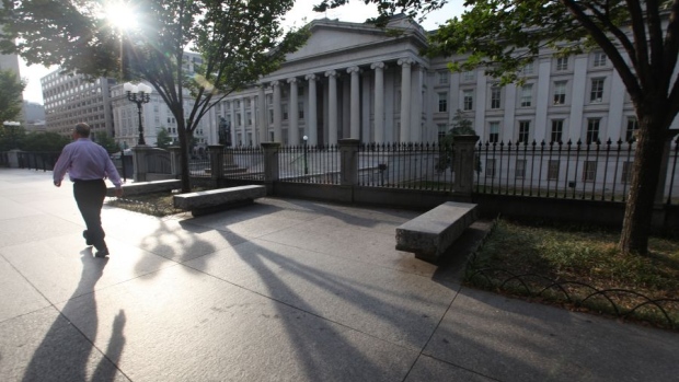 A pedestrian passes in front of the closed U.S. Treasury building in Washington D.C., U.S. 