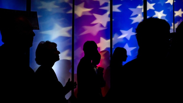 The silhouettes of attendees are seen during a campaign rally for Senator Ted Cruz, a Republican from Texas, in Fort Worth, Texas, U.S., on Friday, Nov. 2, 2018. Cruz is holding on to a narrow lead over Democratic challenger Beto O'Rourke among likely voters. 