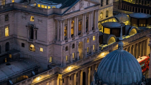 The Bank of England stands illuminated at dawn in the City of London. 