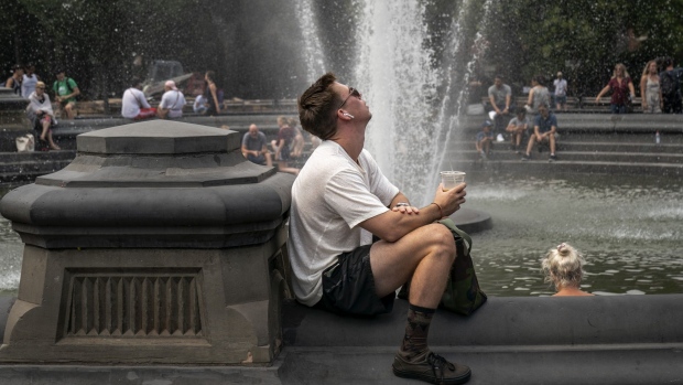 People cool off near the fountain at Washington Square Park, New York on July 17. Photographer: Drew Angerer/Getty Images