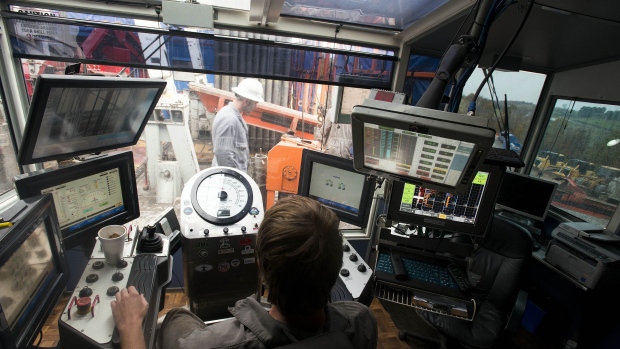A tool pusher, front, controls the drilling rig at a hydraulic fracturing site owned by EQT Corp. located atop the Marcellus shale rock formation in Washington Township, Pennsylvania, U.S. 