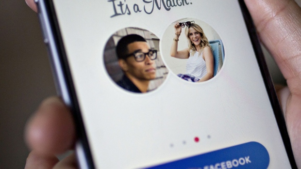 The Tinder application is demonstrated for a photograph on an Apple Inc. iPhone in Washington, D.C., U.S., on Saturday, Feb. 4, 2017. IAC/InterActiveCorp, parent of Match Group Inc. which operates a number of dating services including Tinder, beat analysts estimates for revenue and profit in the fourth quarter when figured were released on January 31. 