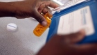 Rosemary Petty, a Publix Supermarket pharmacy technician, counts out a prescription of antibiotic pills August 7, 2007 in Miami, Florida