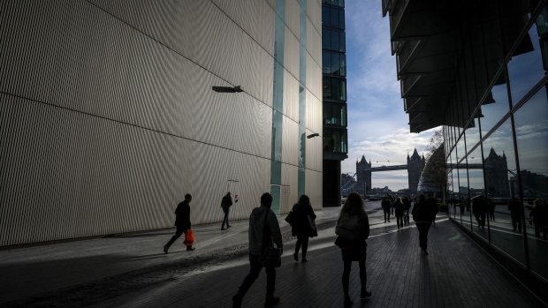 Pedestrians walk through More London Retail and office development in London. 