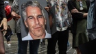 A protest group holds up signs of Jeffrey Epstein in front of the Federal courthouse in New York on July 8, 2019. Photographer: Stephanie Keith/Getty Images