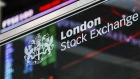 The London Stock Exchange (LSE) logo sits in front of FTSE 100 Index share price information in the atrium of the London Stock Exchange Group Plc's offices in London, U.K., on Wednesday, May 29, 2019. 