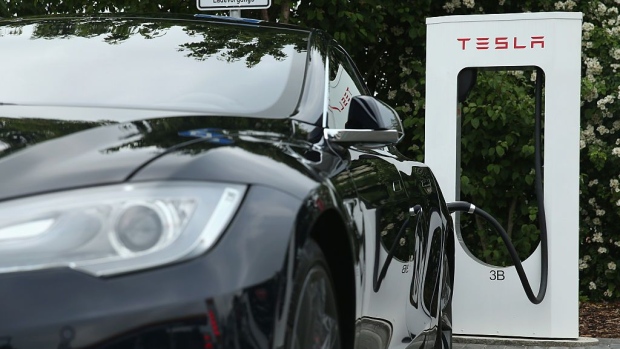 RIEDEN, GERMANY - JUNE 11: A Tesla electric-powered sedan stands at a Tesla charging  at a highway reststop along the A7 highway on June 11, 2015 near Rieden, Germany.