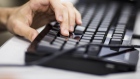 An attendee types on a keyboard during the MarketplaceLIVE Hackathon, sponsored by Digital Realty Trust Inc., in New York, U.S., on Thursday, Sept. 22, 2016. Digital Realty Trust's clients include domestic and international companies ranging from financial services, cloud and information technology services, to manufacturing, energy, gaming, life sciences and consumer products. 