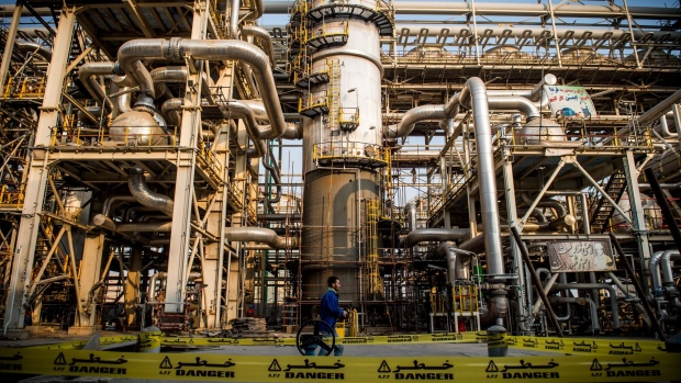 A worker passes a cordoned-off 'Danger' zone at the Bushehr Petrochemical Co. plant under construction in the Pars Special Economic and Energy Zone in Asaluyeh, Iran, on Monday, July 8, 2019. Shipping in the Middle East is getting ever riskier, with a standoff between the U.K. navy and Iran just the latest in a line of incidents in the region over the past few months. 